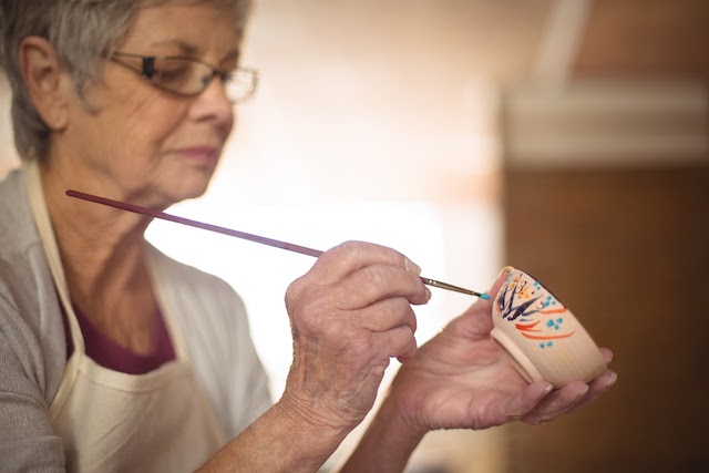 Woman doing pottery - seniors helping seniors